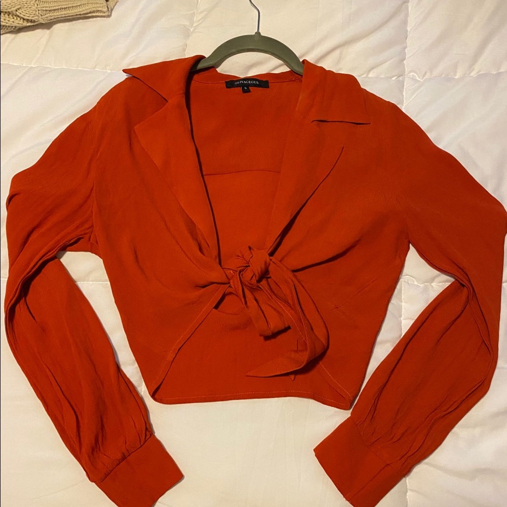 Burnt orange long sleeve wrap shirt.